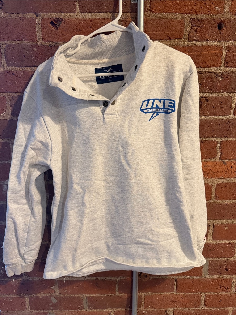 League light gray pullover sweatshirt with blue UNE logo